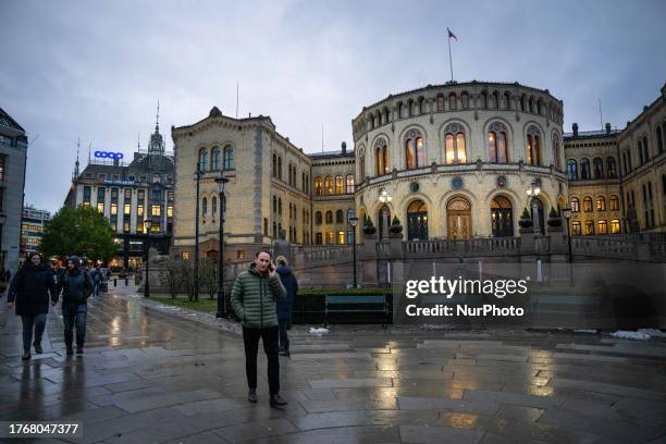 Several people are seen walking by the Norwegian parliament building in downtown Oslo. 03 November 2023. Oslo is the capital of Norway and is located...