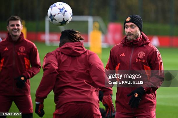 Manchester United's English midfielder Mason Mount, Manchester United's English defender Aaron Wan-Bissaka and Manchester United's Danish midfielder...