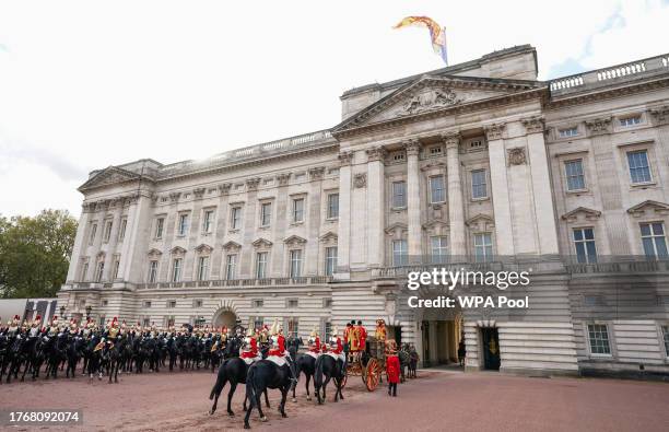 The procession arrives back at Buckingham Palace, following the State Opening of Parliament in the House of Lords at the Palace of Westminster, on...