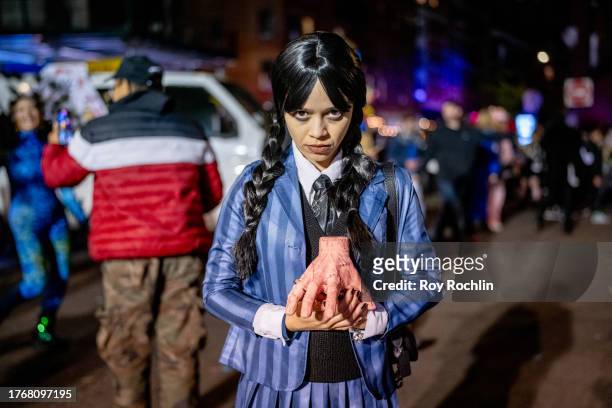 Parade participant is seen in a Wednesday Addams costume during the Village Halloween Parade in Manhattan on October 31, 2023 in New York City.