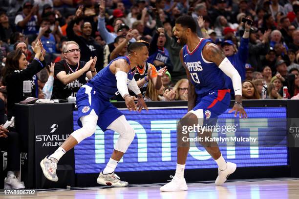 Paul George of the Los Angeles Clippers celebrates a three-point basket with teammate Russell Westbrook during the third quarter against the Orlando...