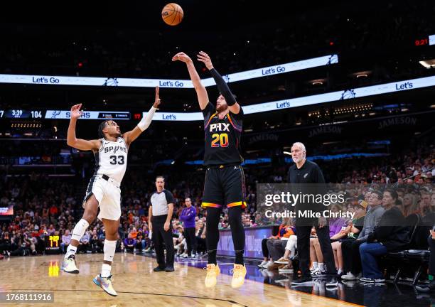 Jusuf Nurkic of the Phoenix Suns shoots a three-pointer over Tre Jones of the San Antonio Spurs as San Antonio Spurs head coach Gregg Popovich,...