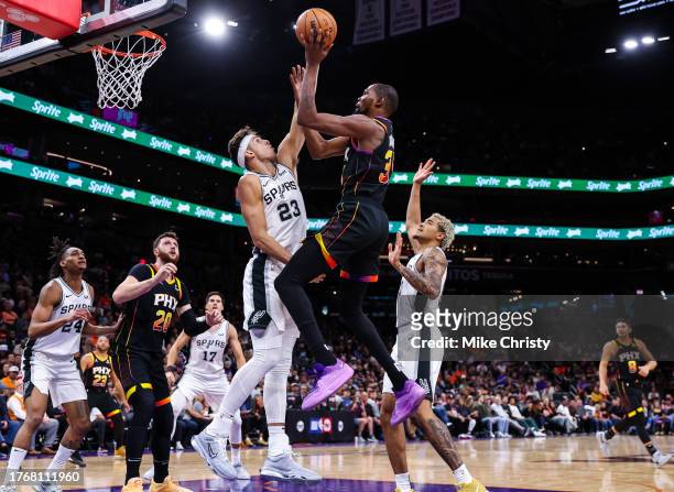 Kevin Durant of the Phoenix Suns floats in for a shot over Zach Collins of the San Antonio Spurs during the fourth quarter of an NBA game at...
