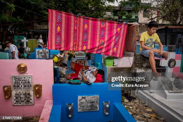 Filipinos visit the graves of departed loved ones as they mark All Saints' Day at Manila North Cemetery on November 01, 2023 in Manila, Philippines....