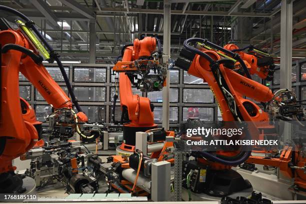 Robot arms assemble electric engines at the plant of AUDI Hungary, one of the world's largest engine factories, in Gyor, Hungary on November 7 after...