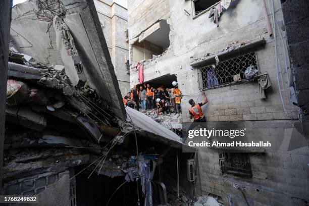 November 1: People search through buildings that were destroyed during Israeli air raids in the southern Gaza Strip November 1 2023 in Khan Yunis,...