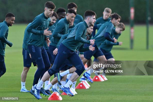 Arsenal's English midfielder Declan Rice takes part with teammates in a training session at Arsenal's training ground in north London on November 7...