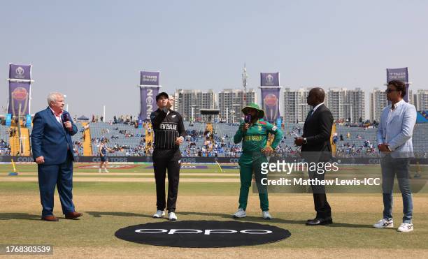 Tom Latham of New Zealand flips the coin as Temba Bavuma of South Africa looks on ahead of the ICC Men's Cricket World Cup India 2023 between New...