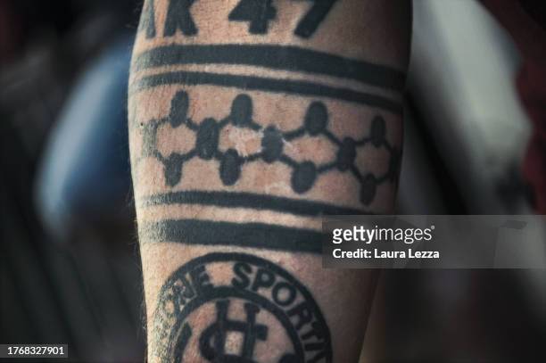 Fan of US Livorno Calcio football team with an old tattoo of a keffiyeh in honor of the struggle for the liberation of Palestine and a tattoo of US...