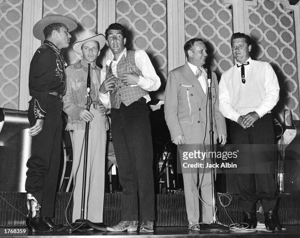 American singers Tony Martin, Frank Sinatra , Dean Martin , Gene Autrey and Gordon McRae perform on stage in Western costumes at a SHARE benefit...