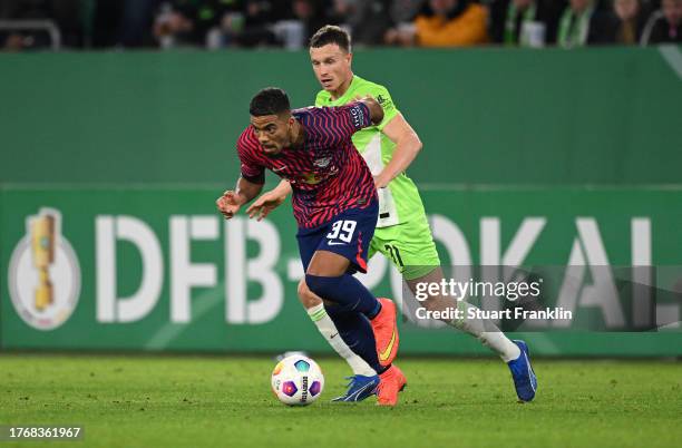 Yannick Gerhardtof Wolfsburg challenges Benjamin Henrichs of Leipzig during the DFB cup second round match between VfL Wolfsburg and RB Leipzig at...