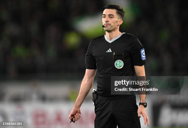 Referee Florian Badstuebner looks on during the DFB cup second round match between VfL Wolfsburg and RB Leipzig at Volkswagen Arena on October 31,...