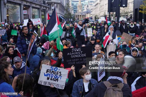 Protestors stage a temporary sit-in in Oxford Circus, blocking all traffic as tens of thousands of pro-Palestine demonstrators gathered to demand an...