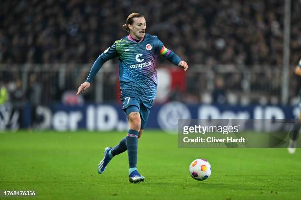 Jackson Irvine of FC St. Pauli runs with the ball during the DFB cup second round match between FC St. Pauli and FC Schalke 04 at Millerntor Stadium...