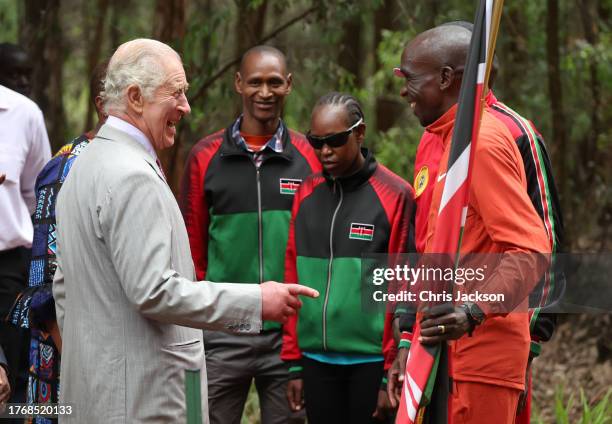 King Charles III laughs as he shares a joke with Kenyan marathon runner Eliud Kipchoge, ahead of the start of 15km "Run for Nature" event during a...