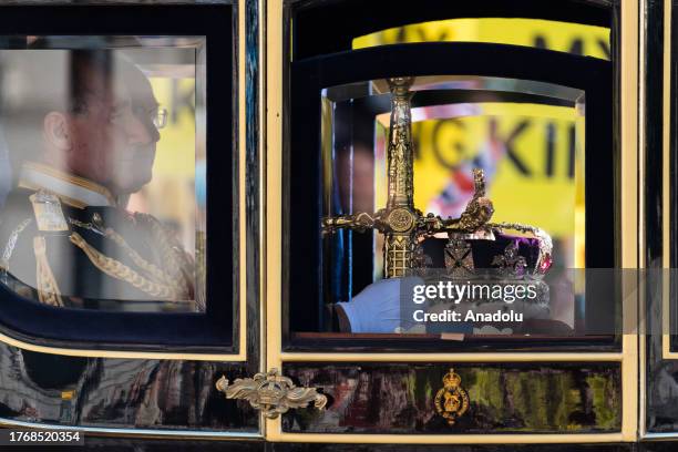 Coach is seen carrying the Imperial State Crown and the Great Sword of State travels along Whitehall to the Houses of Parliament for the State...