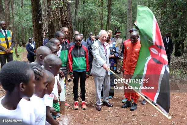 King Charles III with Kenyan marathon runner Eliud Kipchoge as they flag off to start a 15km "Run for Nature" event during a visit to Karura urban...