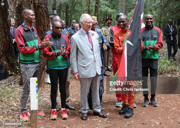 King Charles III with Kenyan marathon runner Eliud Kipchoge react after they flag off to start a 15km "Run for Nature" event during a visit to Karura...