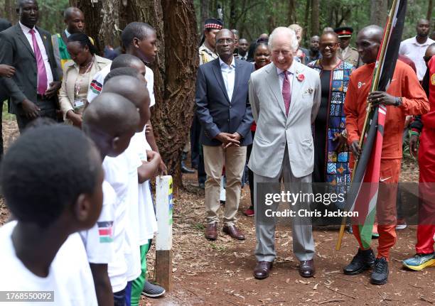 King Charles III smiles with Kenyan marathon runner Eliud Kipchoge , as they flag off to start a 15km "Run for Nature" event during a visit to Karura...