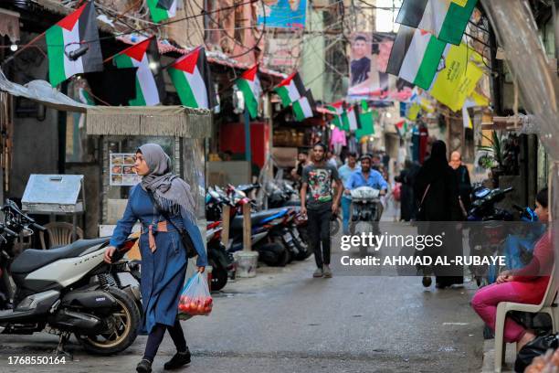 Palestinian flags hanging along an alley at the Shatila camp for Palestinian refugees in the southern suburb of Beirut on November 7, 2023 amid...