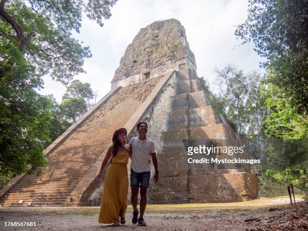 couple sightseeing the tikal ruins - ancient ruins stock pictures, royalty-free photos & images