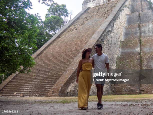 couple sightseeing the tikal ruins - ancient ruins stock pictures, royalty-free photos & images