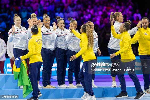 October 04: The French team on the podium to receive their bronze medals are congratulated by silver medal winners Brazil after the Women's Team...