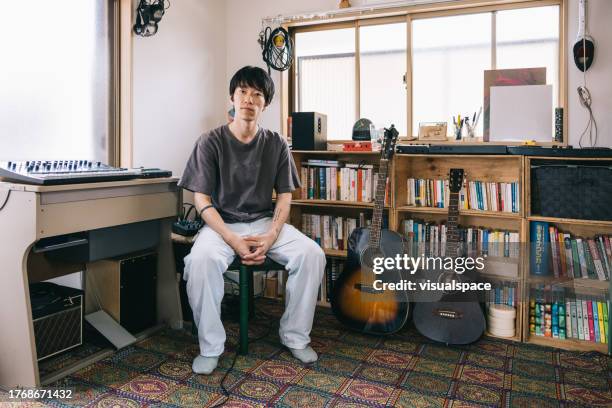 portrait of young japanese musician in his home studio corner - låtskrivare bildbanksfoton och bilder