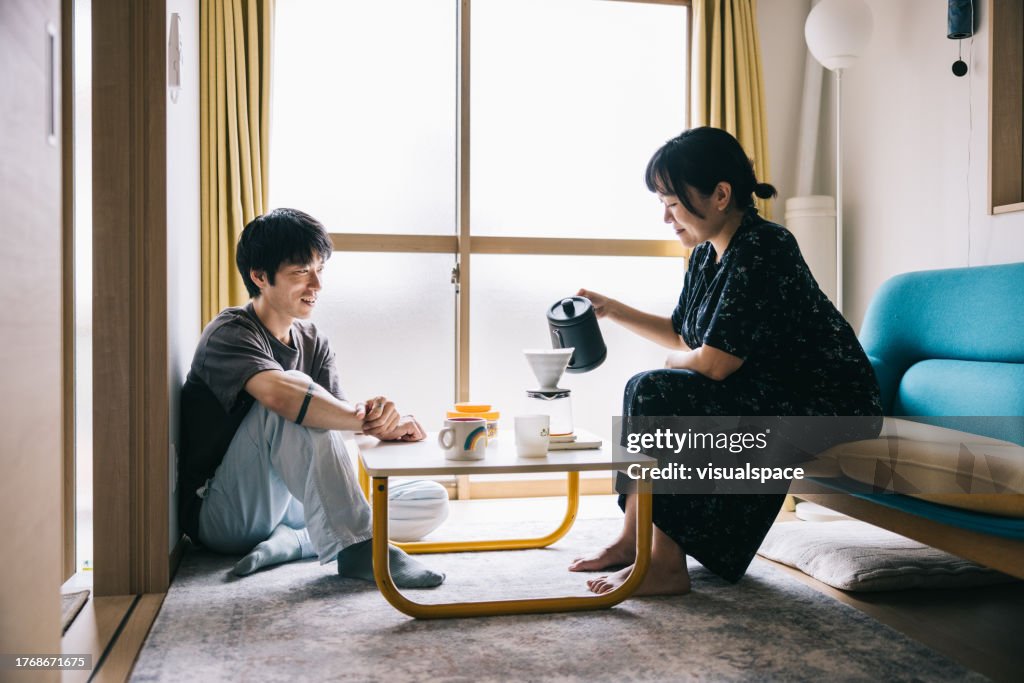 Young couple having a coffee break at home