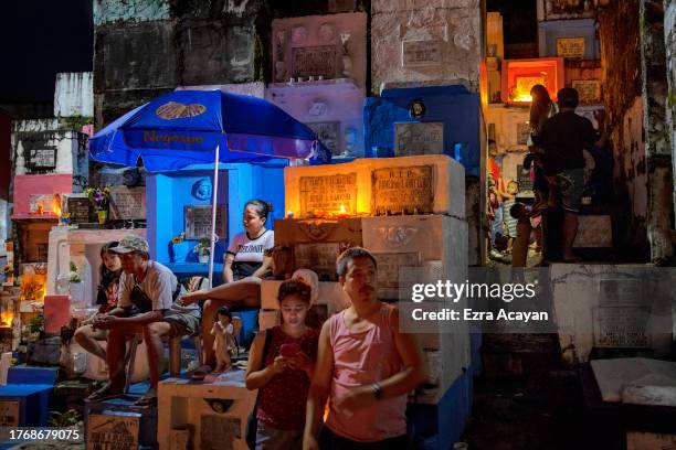 Filipinos visit the graves of departed loved ones as they mark All Saints' Day at Barangka Municipal Cemetery on November 01, 2023 in Marikina, Metro...