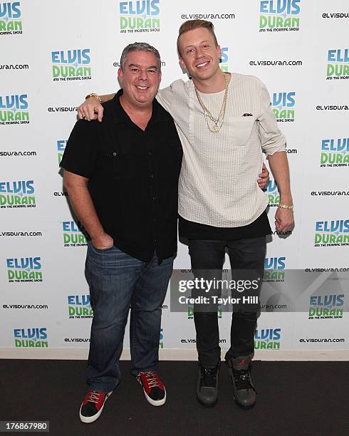 Radio personality Elvis Duran and Macklemore pose together at "The Elvis Duran Z100 Morning Show" at Z100 Studio on August 16, 2013 in New York City.