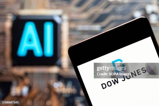 In this photo illustration, the American stock market index of the 30 prominent companies Dow Jones Industrial Average logo seen displayed on a...