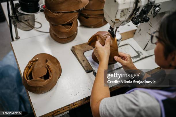 female craftsperson making shoes - brown shoe stock pictures, royalty-free photos & images