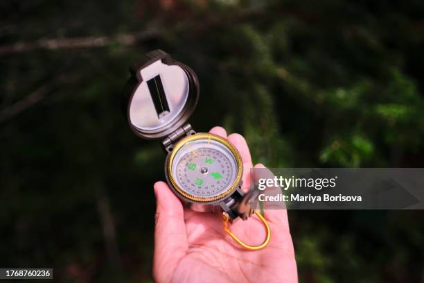 compass in hand close up. - amber alert stock pictures, royalty-free photos & images