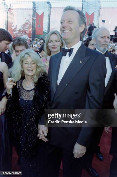 Portia Rebecca Crockett and Peter Fonda attend the 70th Academy Awards at the Shrine Auditorium in Los Angeles, California, on March 23, 1998.