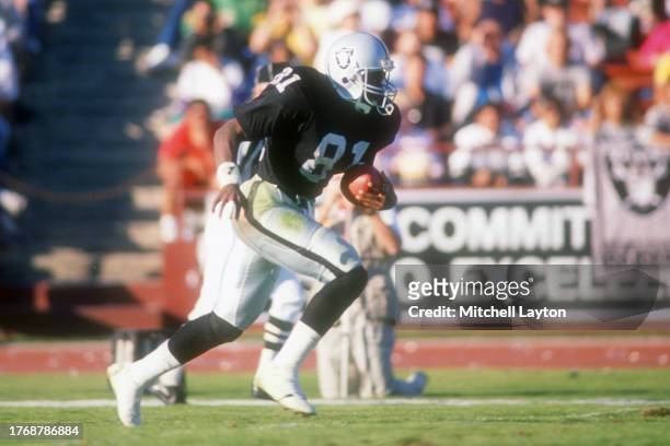 Tim Brown of the Los Angeles Raiders runs with the ball during a football game against the Atlanta Falcons on November 20, 1988 at Los Angeles...