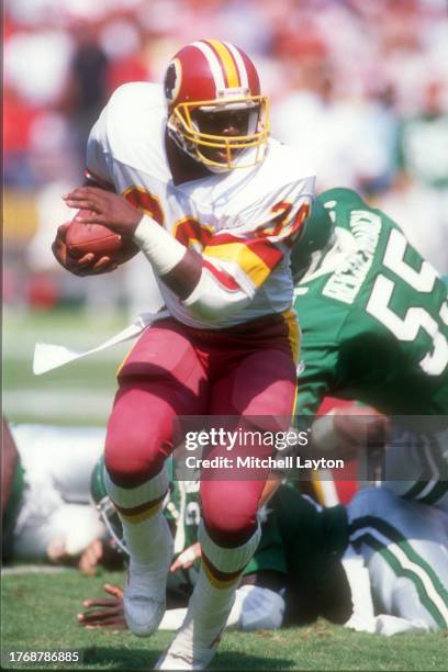 Timmy Smith of the Washington Redskins runs with the ball during a NFL football game against the Philadelphia Eagles on September 18, 1988 at RFK...