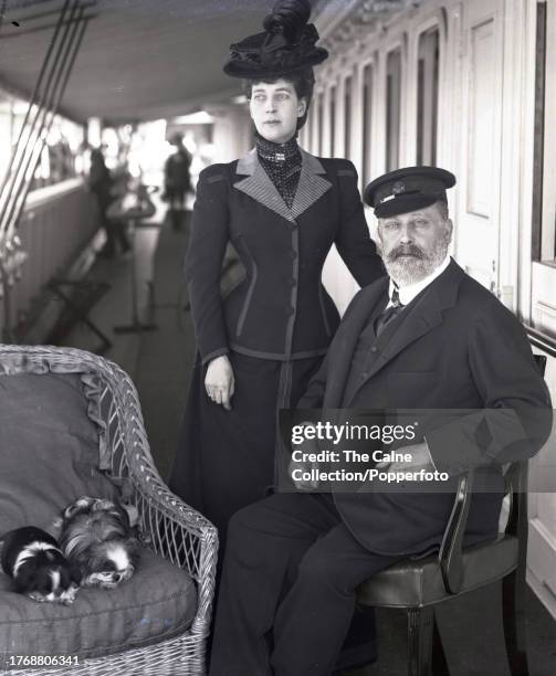 King Edward VII and Queen Alexandra, fine portrait photograph of the relaxed Royal couple with dogs on board the Royal Yacht Victoria & Albert taken...