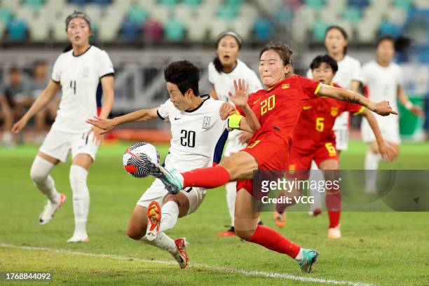 Wurigumula of China and Kim Hye-ri of South Korea compete for the ball during the AFC Women's Asian Olympic Qualifier Round 2 Group B match between...