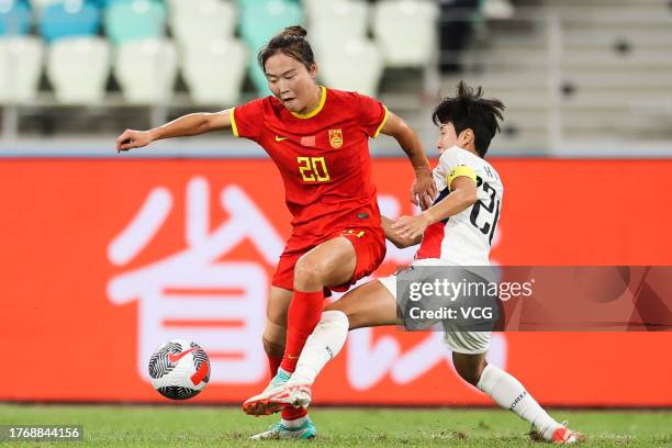 Wurigumula of China and Kim Hye-ri of South Korea compete for the ball during the AFC Women's Asian Olympic Qualifier Round 2 Group B match between...