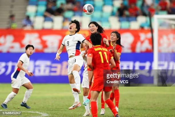 Yang Lina of China and Lee Geum-min of South Korea compete for the ball during the AFC Women's Asian Olympic Qualifier Round 2 Group B match between...