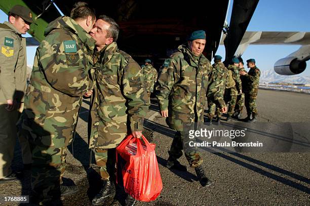 Turkish International Security Assistance Force soldiers say goodbye before boarding a flight back to Turkey at the APOD military base located at the...