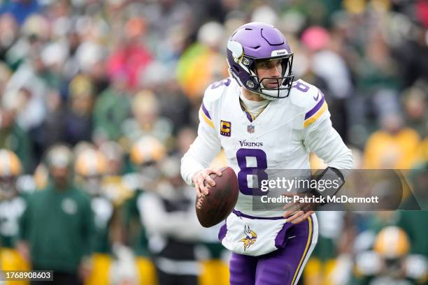 Kirk Cousins of the Minnesota Vikings looks to throw a pass against the Green Bay Packers in the second half at Lambeau Field on October 29, 2023 in...