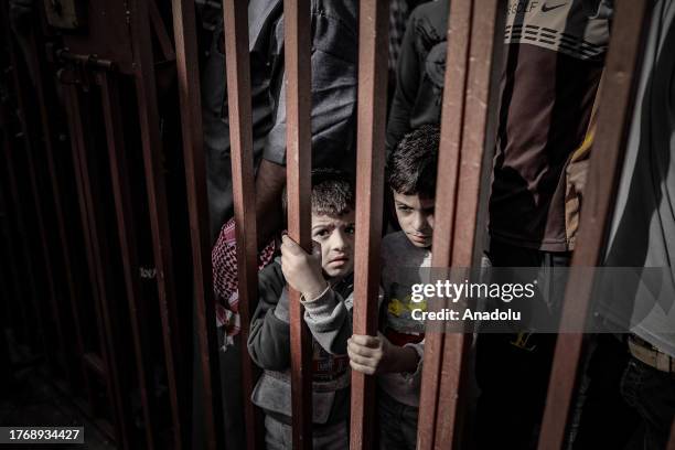 Boys are seen as the dead bodies are brought to a hospital as the Israeli attacks continue on its 32nd day in Deir Al-Balah, Gaza on November 7, 2023.