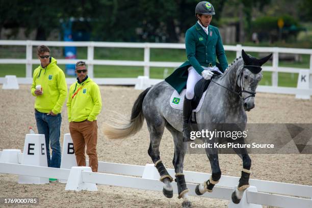 Brazil International coach William Fox-Pitt and Brazilian coach Guto De Faria look on as team rider Marcio Carvalho Jorge onboard Castle Howard...