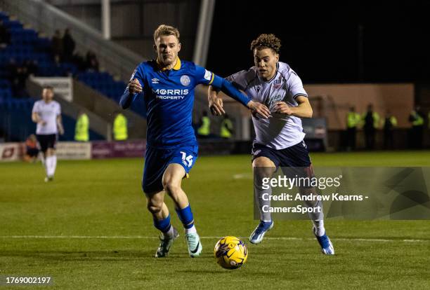 Bolton Wanderers' Dion Charles competing with Shrewsbury Town's Taylor Perry during the Sky Bet League One match between Shrewsbury Town and Bolton...