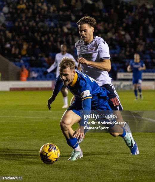 Bolton Wanderers' Dion Charles competing with Shrewsbury Town's Taylor Perry during the Sky Bet League One match between Shrewsbury Town and Bolton...