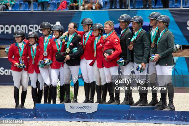 The silver medal winning USA team, the gold medal winning Canadian team and the bronze medal winning Brazilian team team on the podium after the...