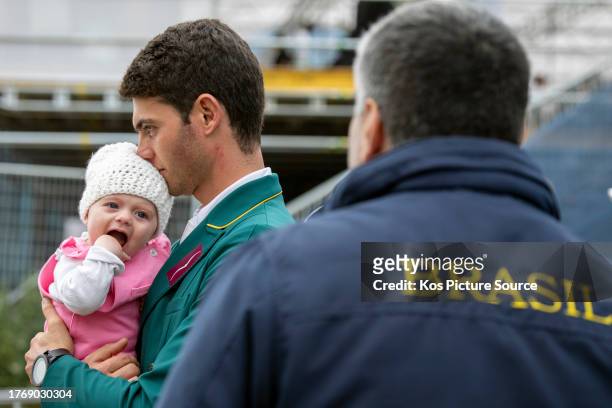 Rafael Mamprin Losano of Brazil with his four month old daughter Stella during the dressage section of the Three day eventing competition at the...
