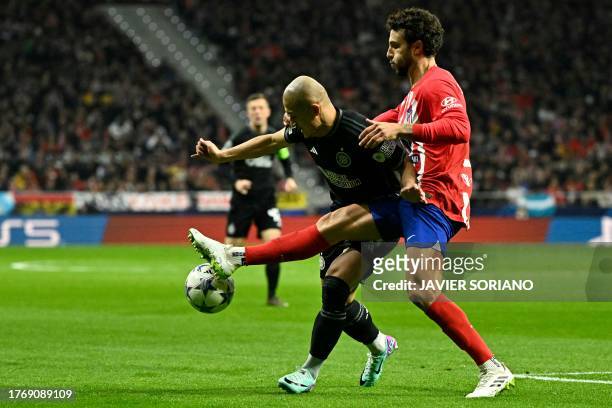 Celtic's Japanese forward Daizen Maeda vies with Atletico Madrid's Spanish defender Mario Hermoso during the UEFA Champions League group E football...